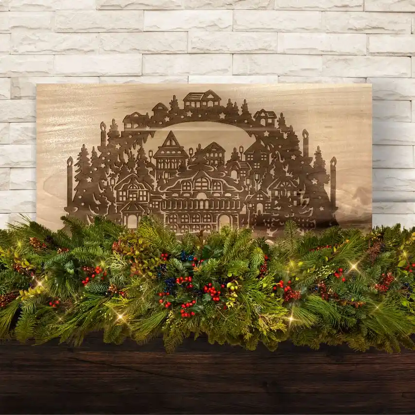 Laser engraved Christmas scene on a piece of maple wood.