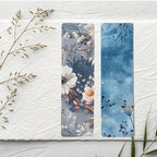 Two floral bookmarks on a textured white surface with dried plants.