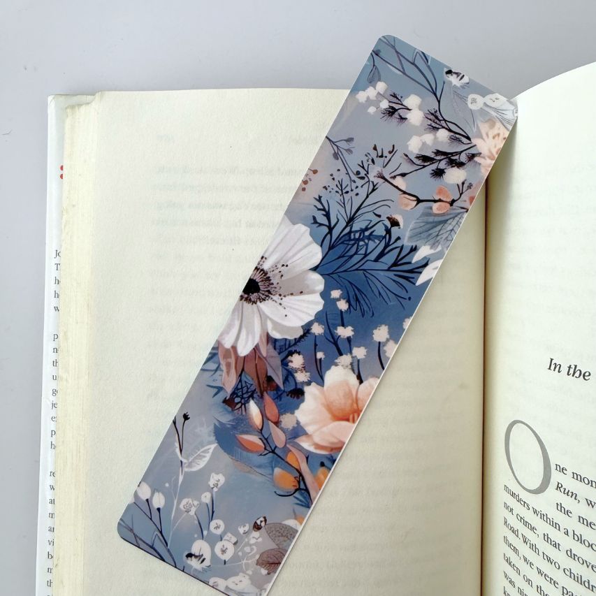 Floral bookmark on an open book with a light gray background