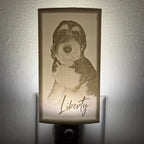 Decorative night light with a dog illustration and 'Liberty' text on a white wall.