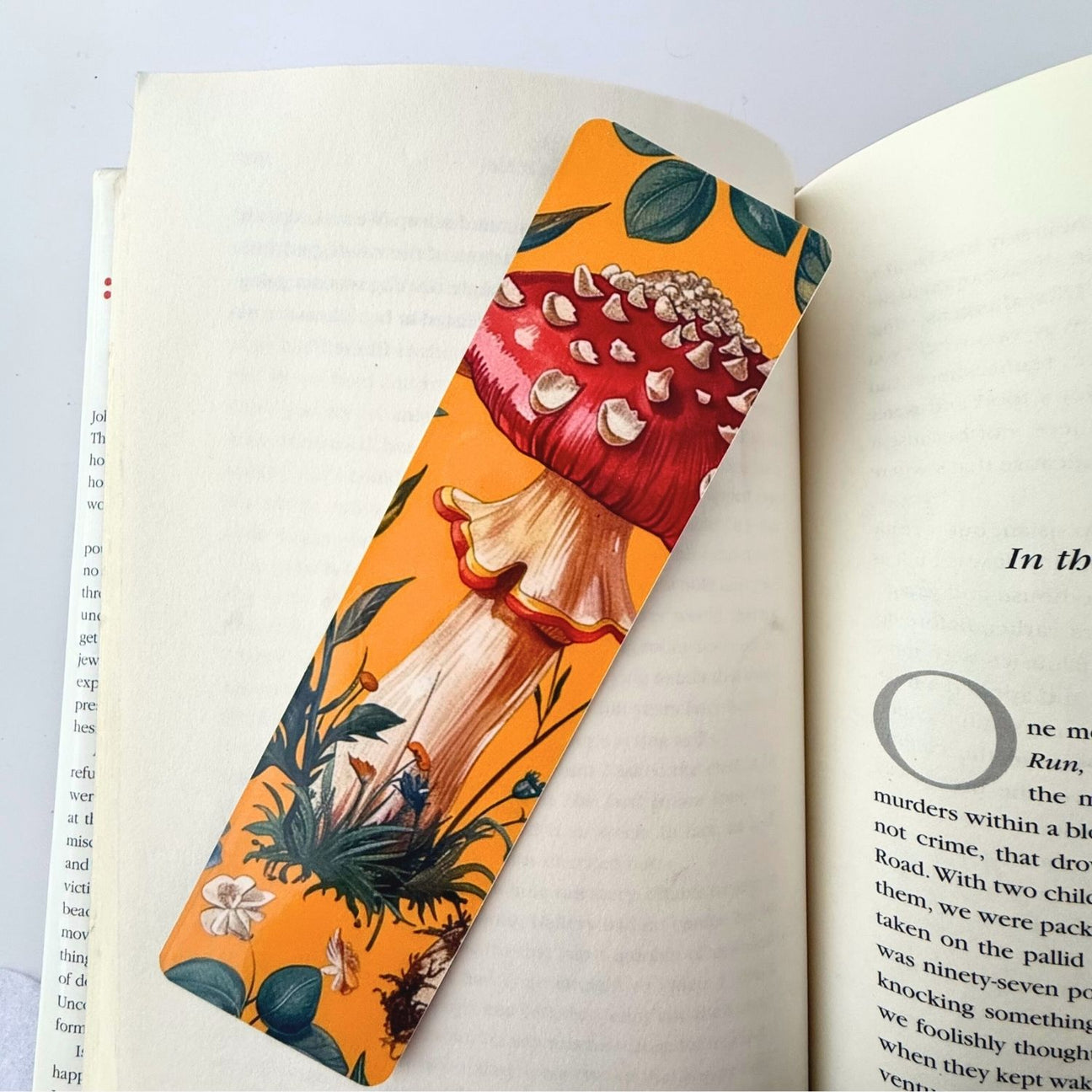 Yellow mushroom bookmark on an open book.