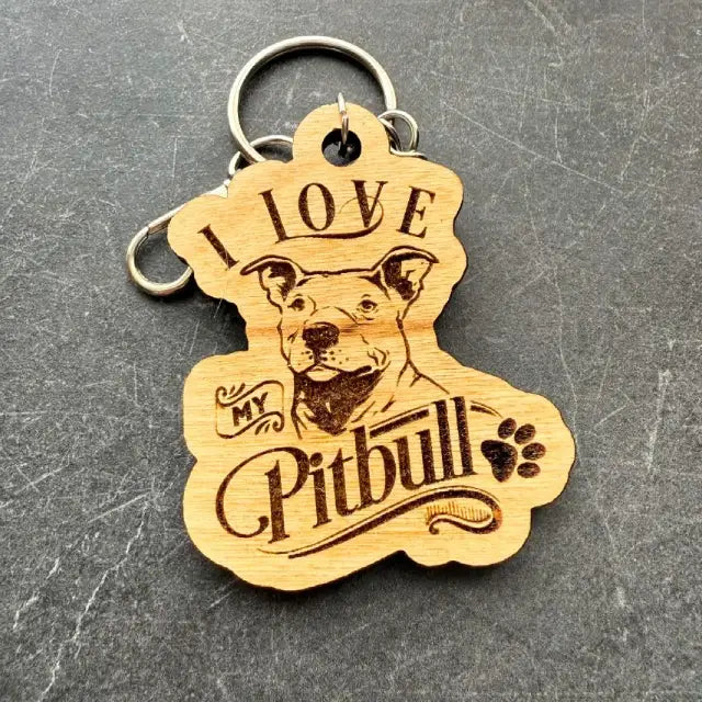 Wooden keychain with 'I love my Pitbull' text and pitbull dog illustration on a gray background