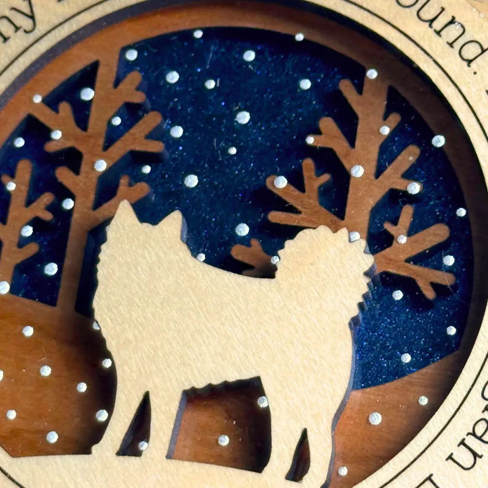 Wooden cutout of a Norwegian Elkhound and trees with a starry night background