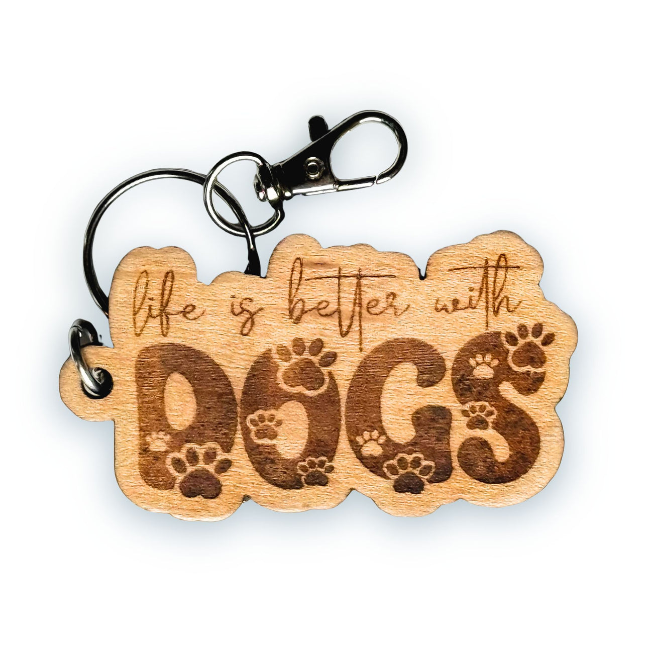 Wooden keychain with 'life is better with dogs' text and paw prints on a white background