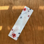 Floral bookmark on a wooden surface