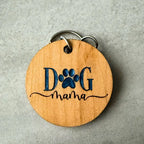 Wooden keychain with 'Dog Mama' engraving on a gray background