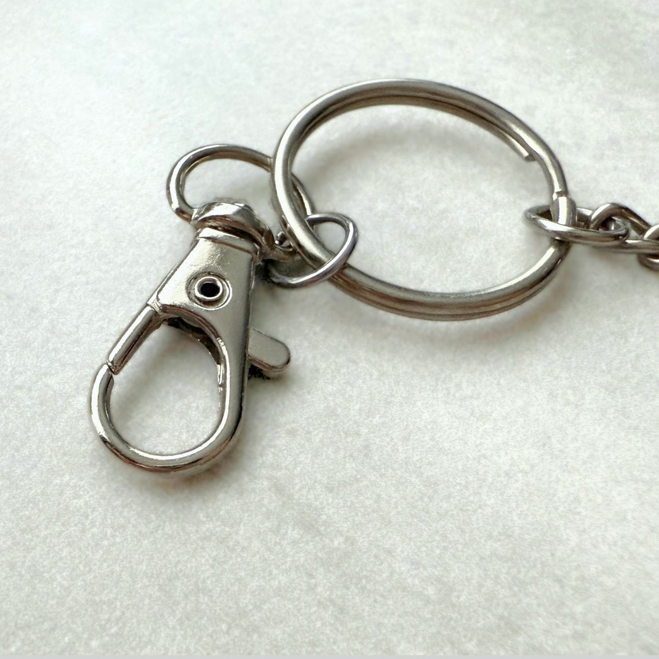 Metal keychain with lobster clasp on a white background
