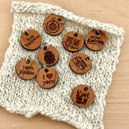 Wooden knitting charms on a knitted fabric background