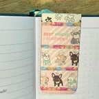 Notebook with a colorful bookmark featuring cartoon dogs and 'Best Friend Forever' text.