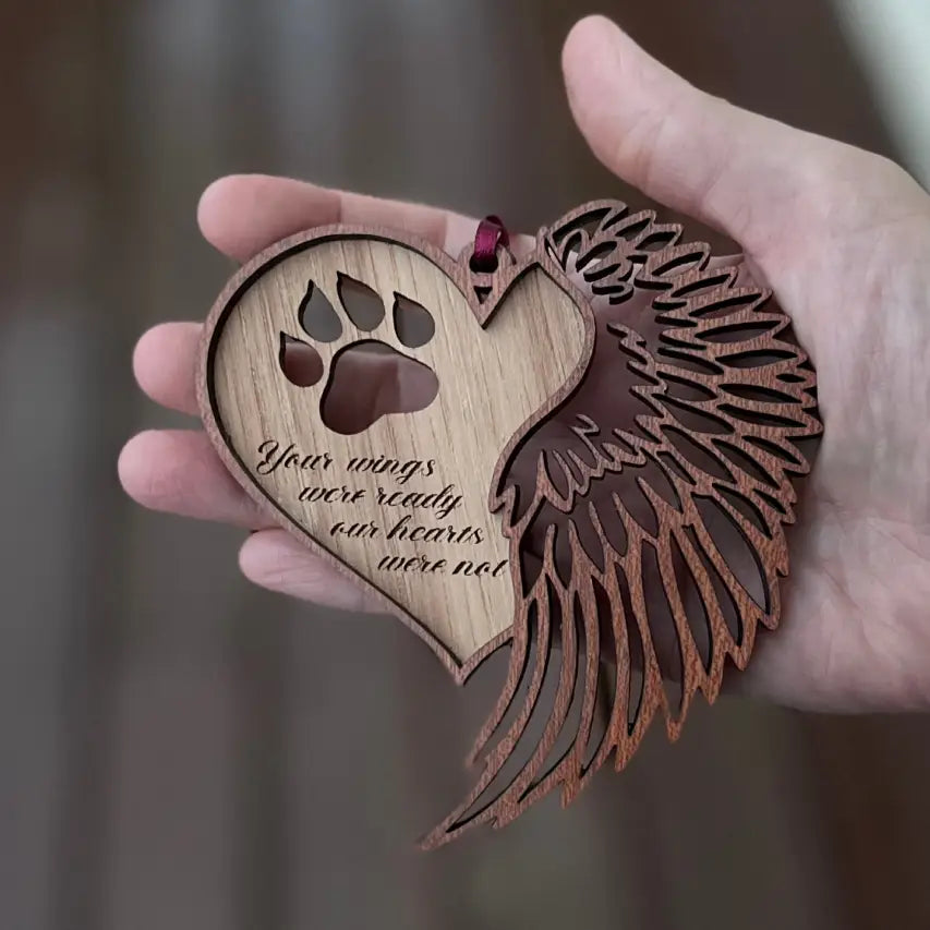 Paw heart memorial ornament held in a hand
