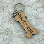 Dog bone-shaped keychain with 'Rescue Mama' text on a textured surface